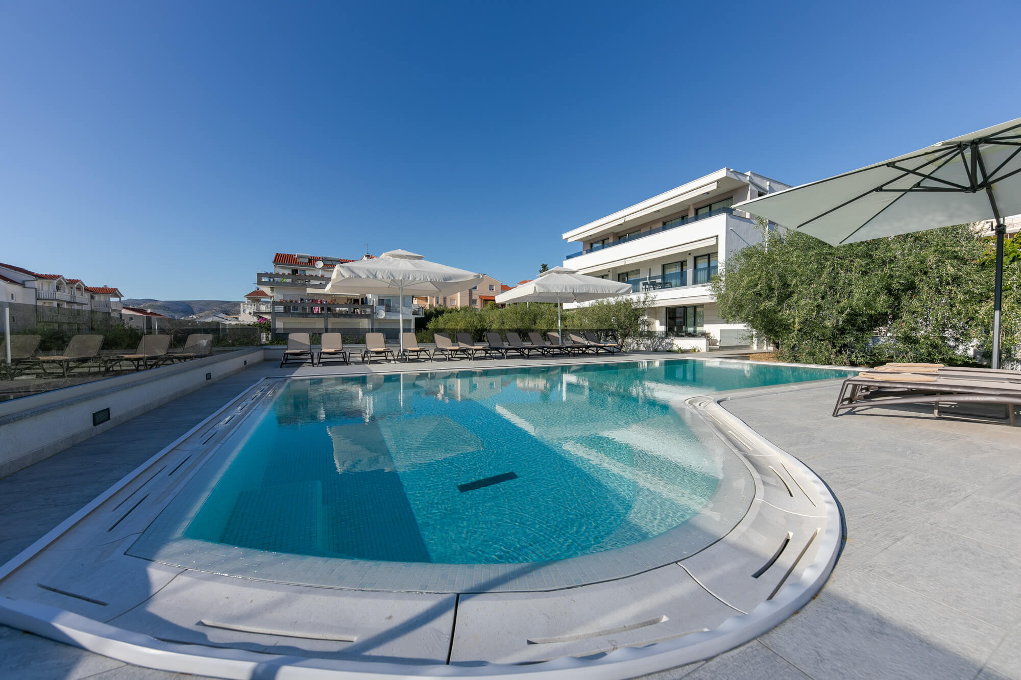 house and pool deck daytime