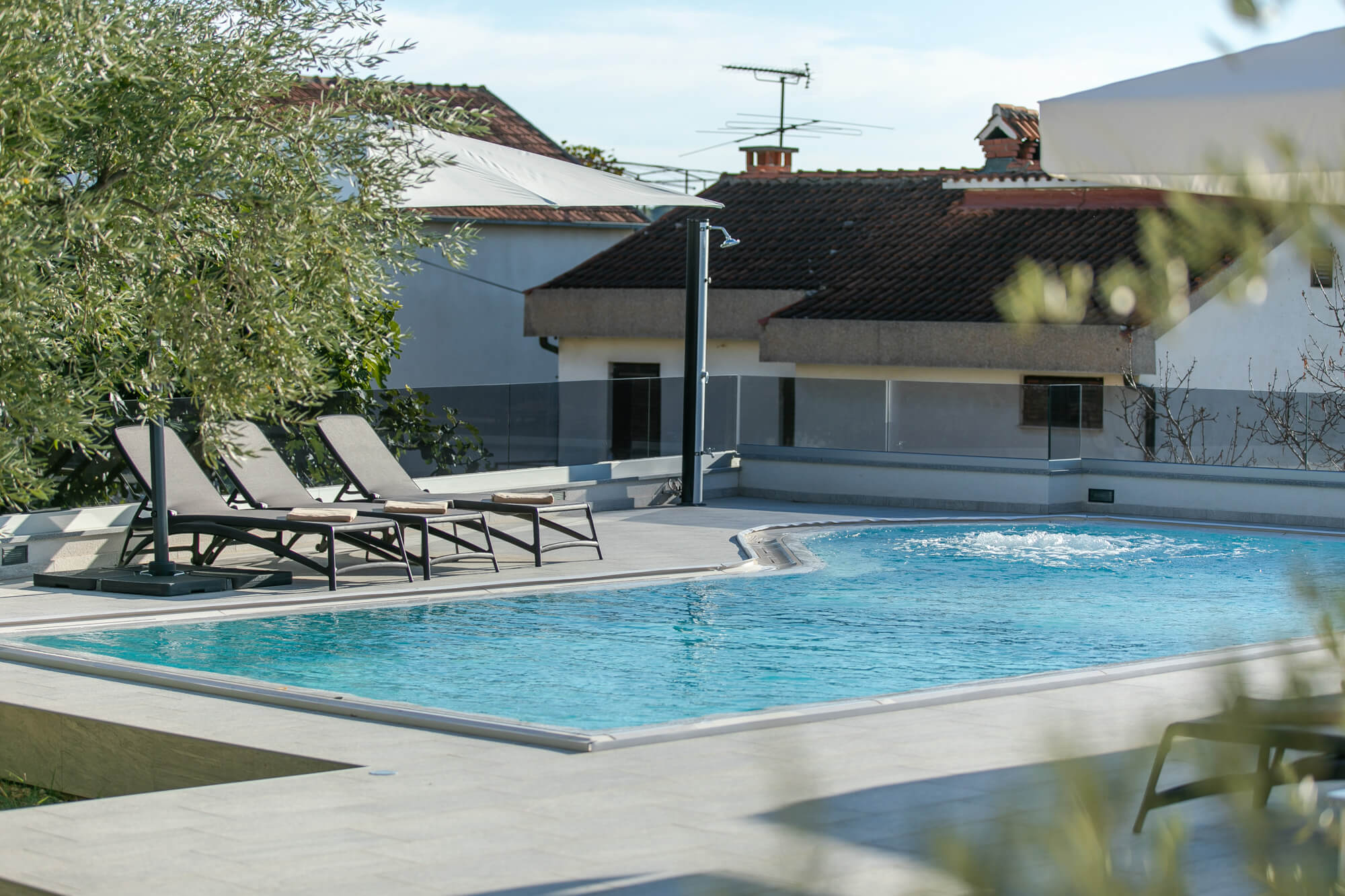 pool, pool deck, lounge chairs during day time